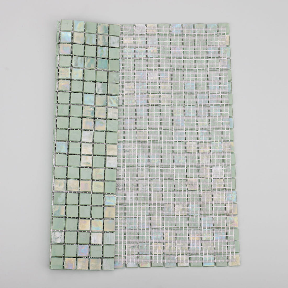 back view of mint green iridescent square glass mosaic tile with mesh backing