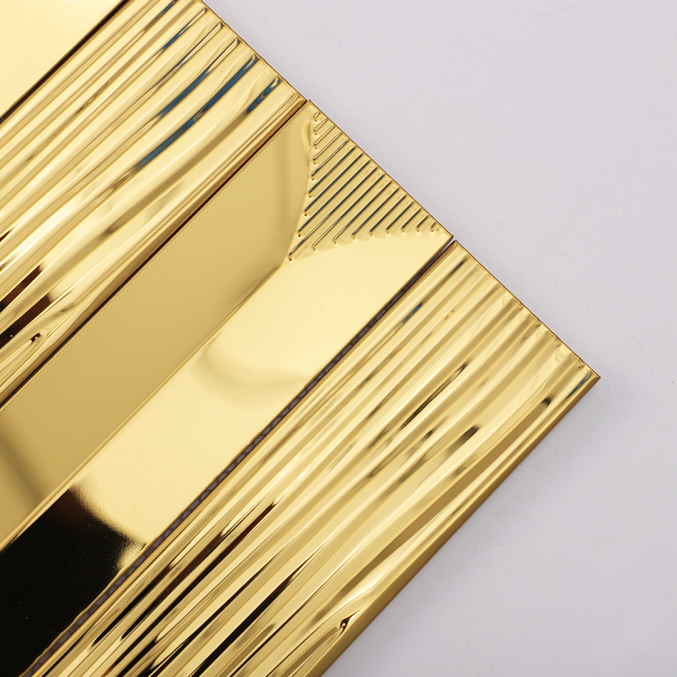 Corner close view of mirror gold linear metal tile with textured ends