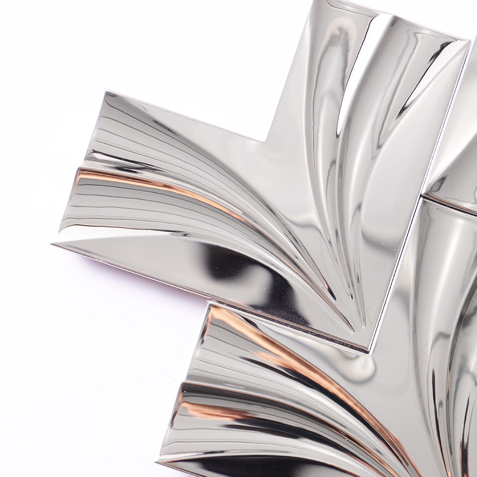 Corner detail of mirror silver chevron stainless steel mosaic tile
