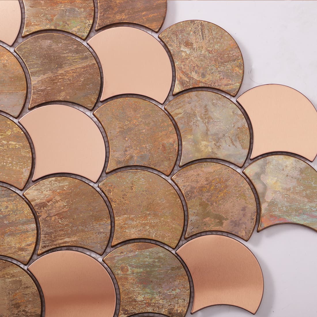 Close-up of mixed copper fish scale metal mosaic tile surface