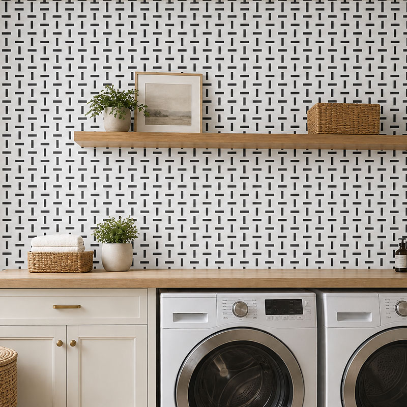 Black and white geometric wall tiles in a modern laundry room with wood shelving