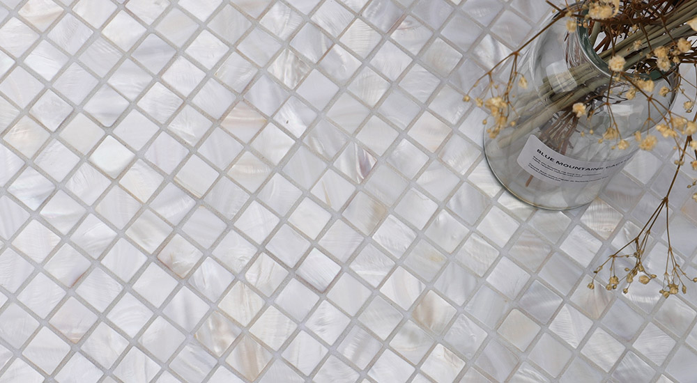 {"default":"Mother of Pearl Square Tiles close-up showing natural nacre glow and organic shell pattern."}

