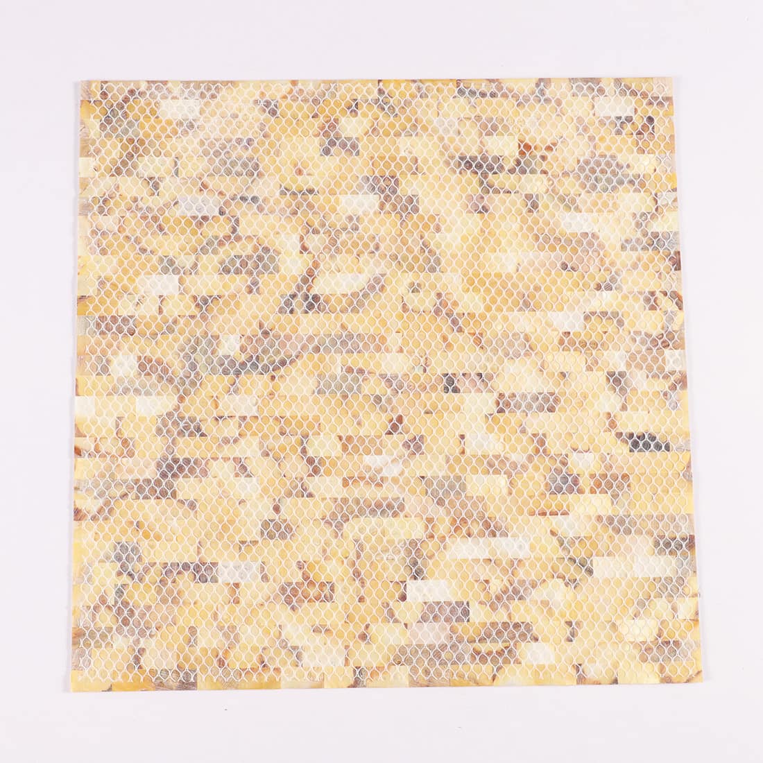Rear view of mesh-backed mother of pearl strip mosaic tile sheet for easy installation.
