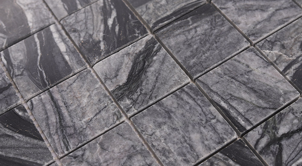{"default":"Close-up of 2 inch tiles in natural marble, 50mm square mosaic for pool and shower."}
