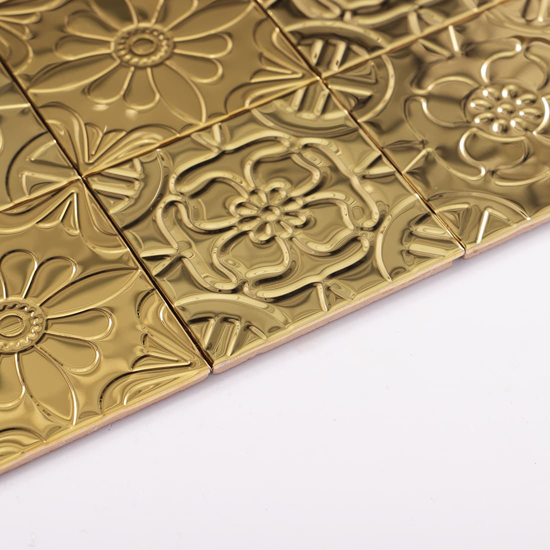 Side view of gold stainless steel embossed mosaic tiles showing thickness