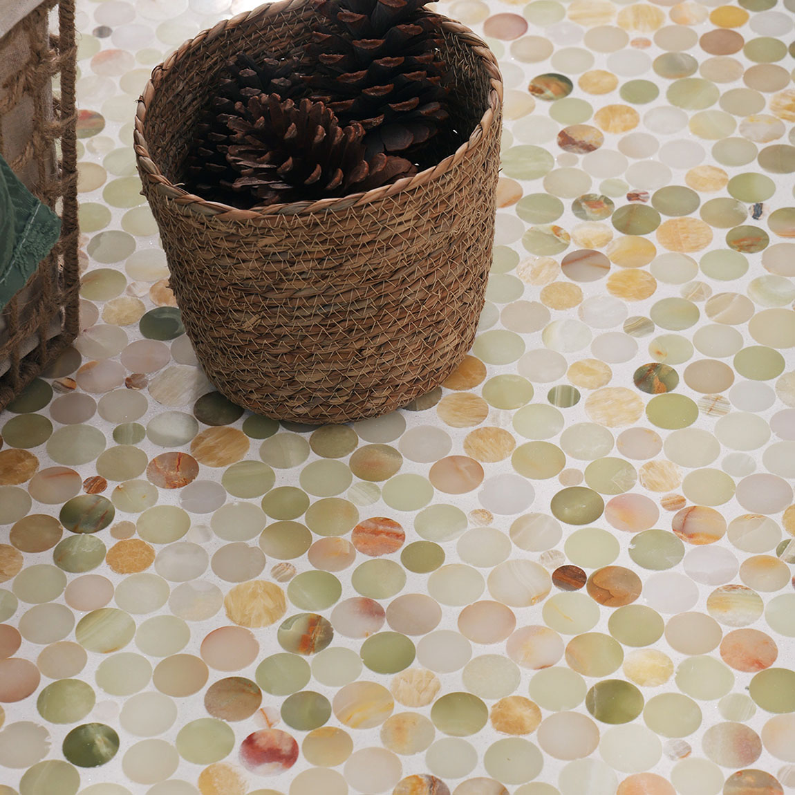 Natural onyx penny round tile installation with a decorative basket