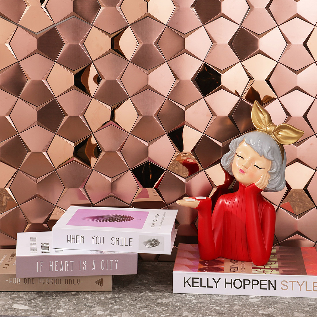 Rose gold star metal mosaic backsplash with books and decorative figure display