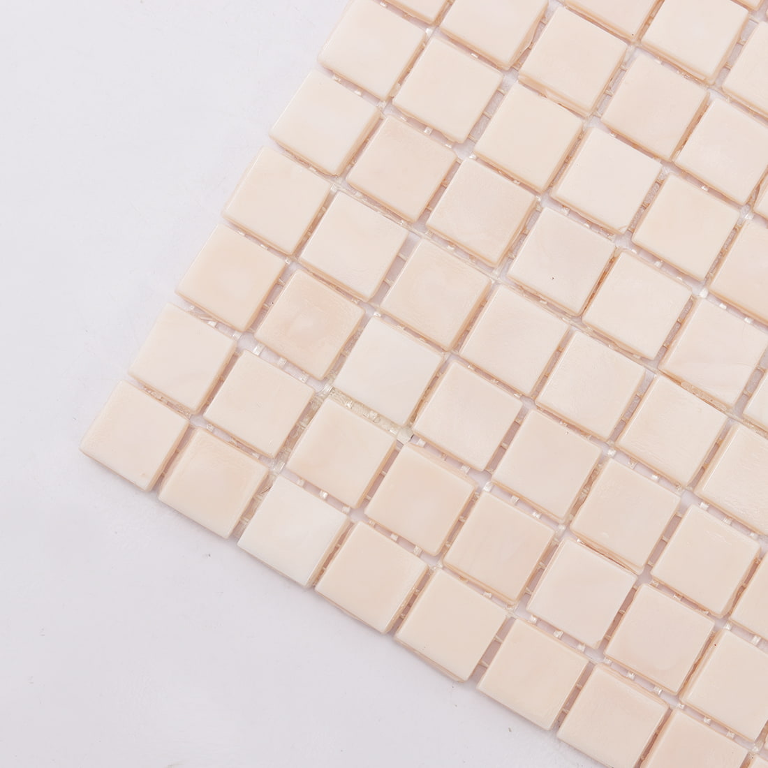 Corner close-up of pale blush square glass mosaic tile