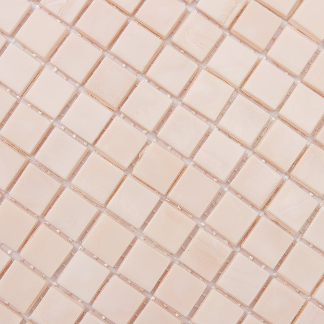 Surface detail of pale blush square glass mosaic tile