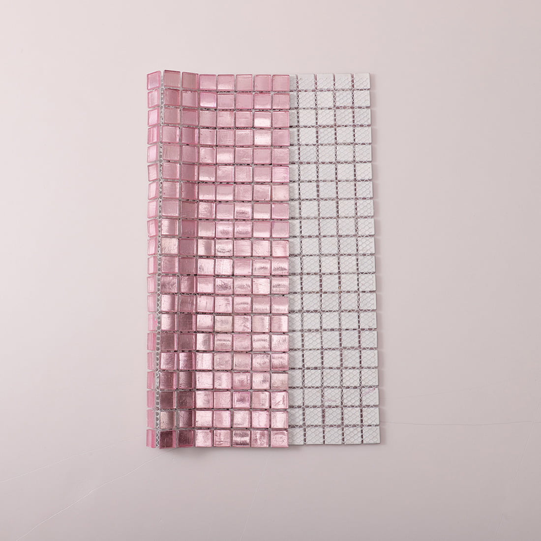 Mesh backing view of pale pink foil-backed glass mosaic tile sheet