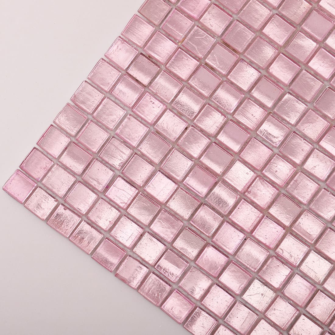 Corner close-up of pale pink foil-backed square glass mosaic