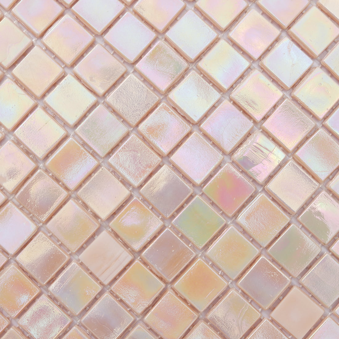 Close-up of pastel iridescent blush pink square glass mosaic surface