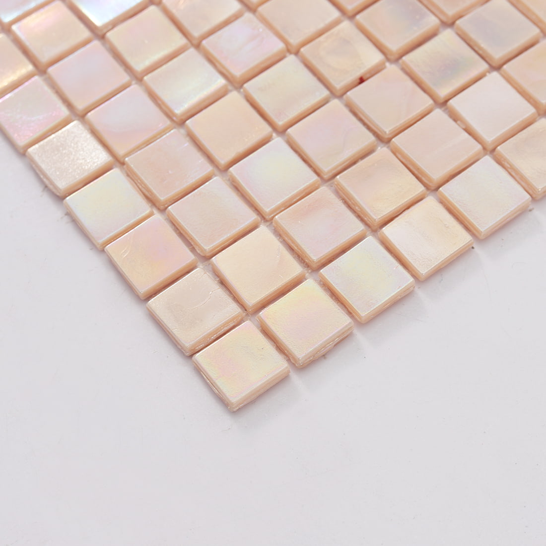 Edge view of pastel iridescent blush pink square glass mosaic tiles