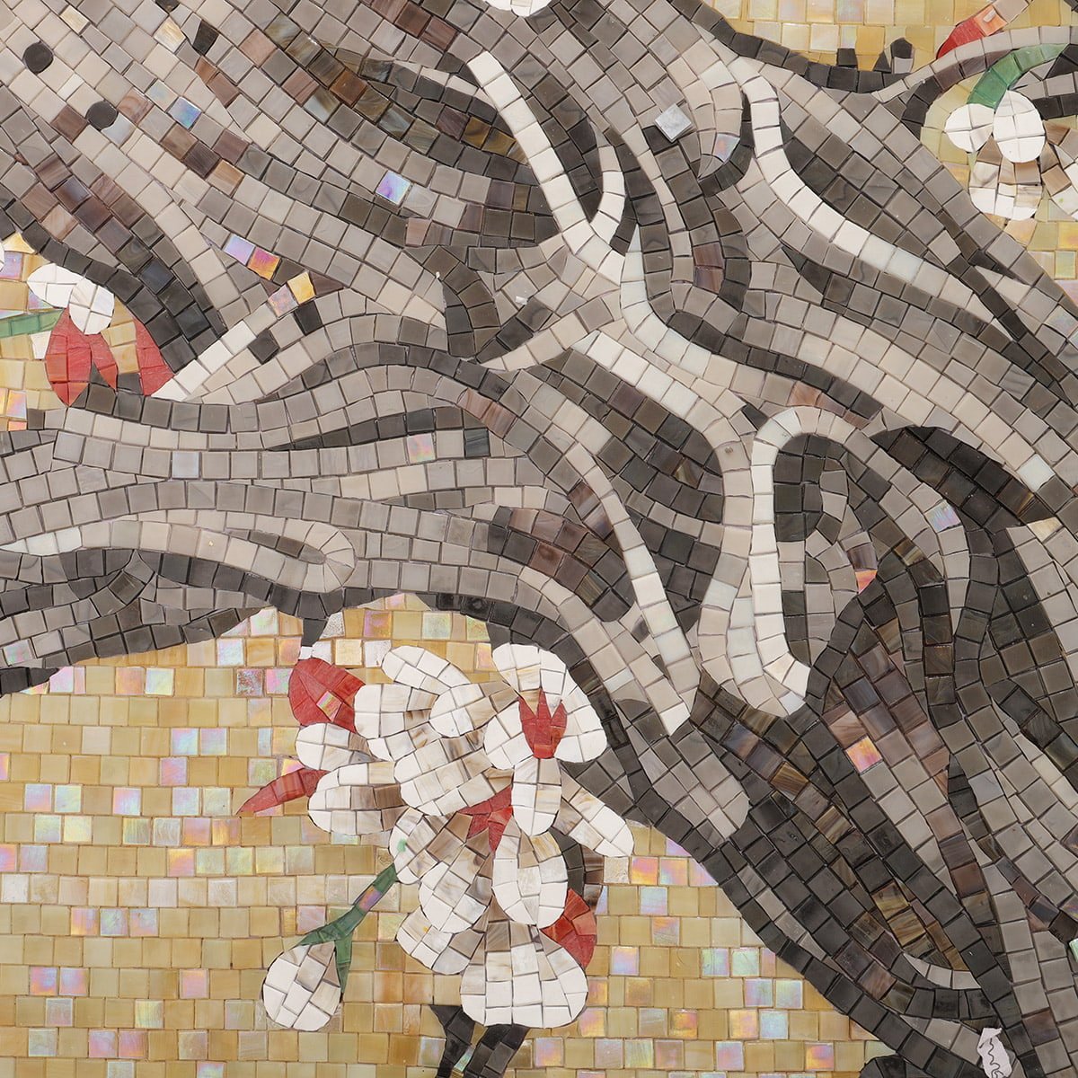 Close-up of handmade mosaic artwork showing detailed tree trunk and white blossoms