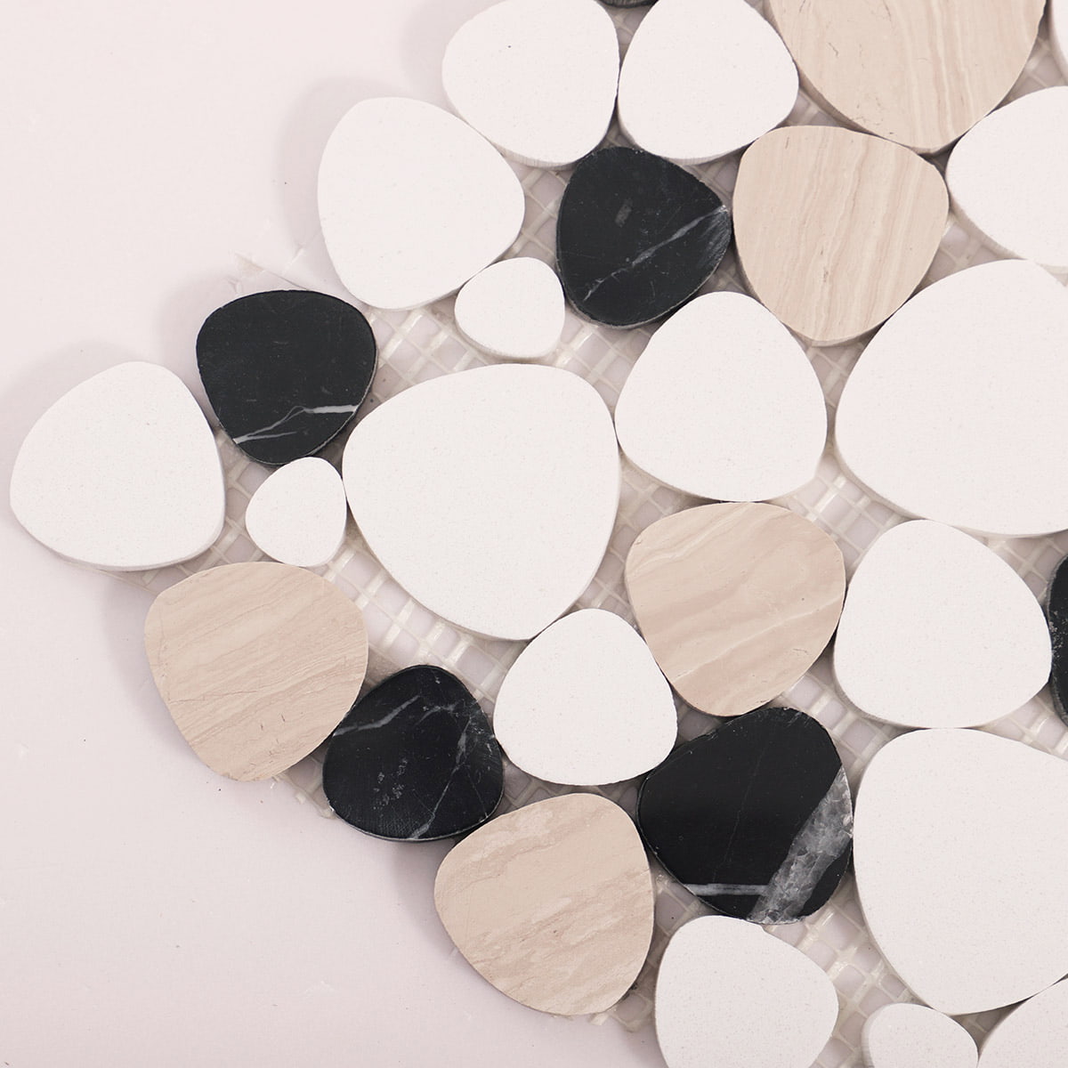 Close up of mixed pebble mosaic tiles at the sheet corner