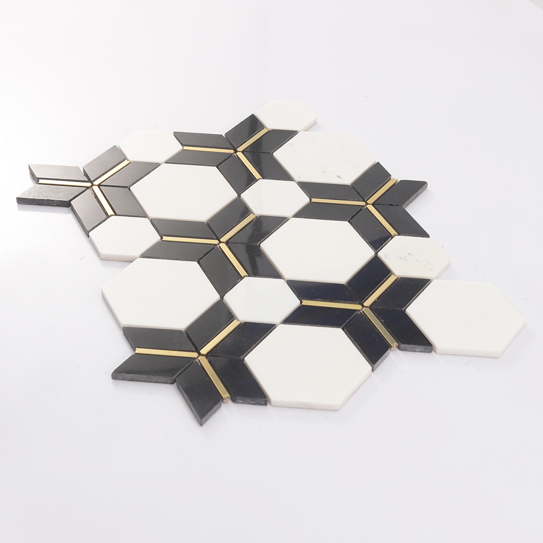 Perspective view of white hexagon mosaic sheet with black accents and gold lines