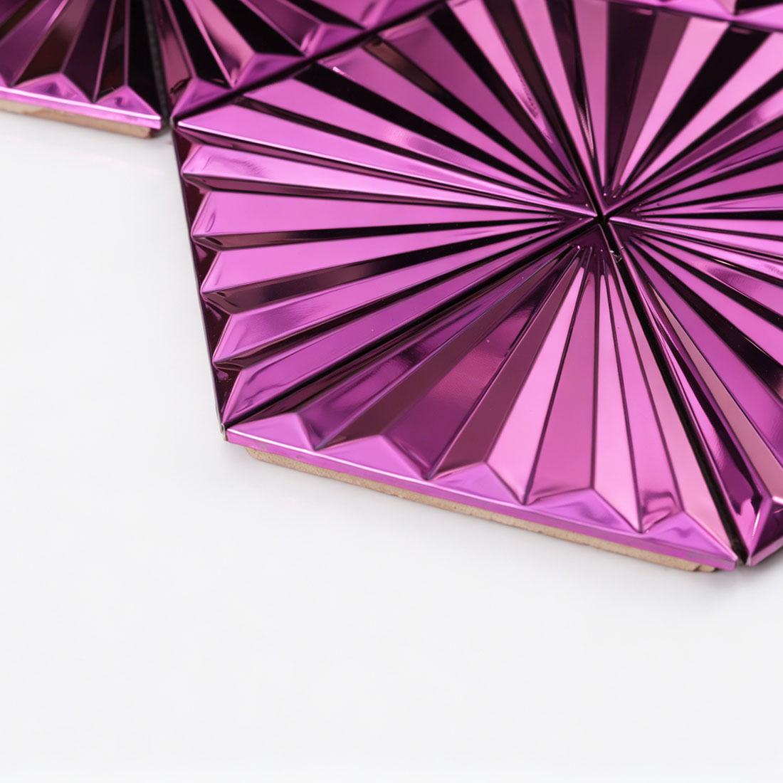Low angle detail of pink mirror fan triangle metal mosaic beveled edge