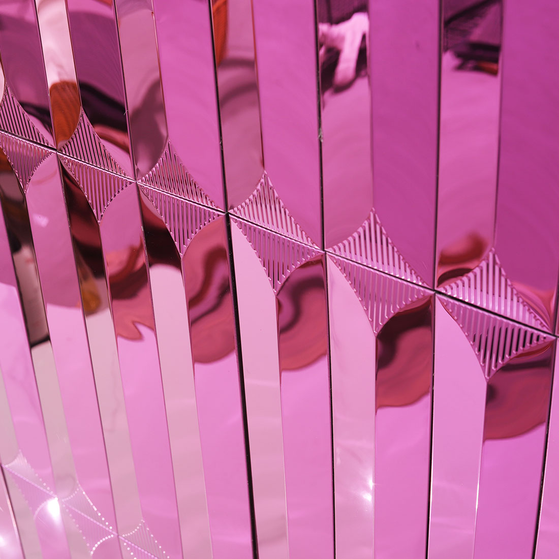 Close-up of pink mirror metal mosaic wall installation