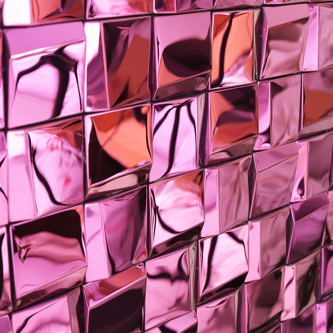 Close-up wall view of pink mirror square metal mosaic tiles