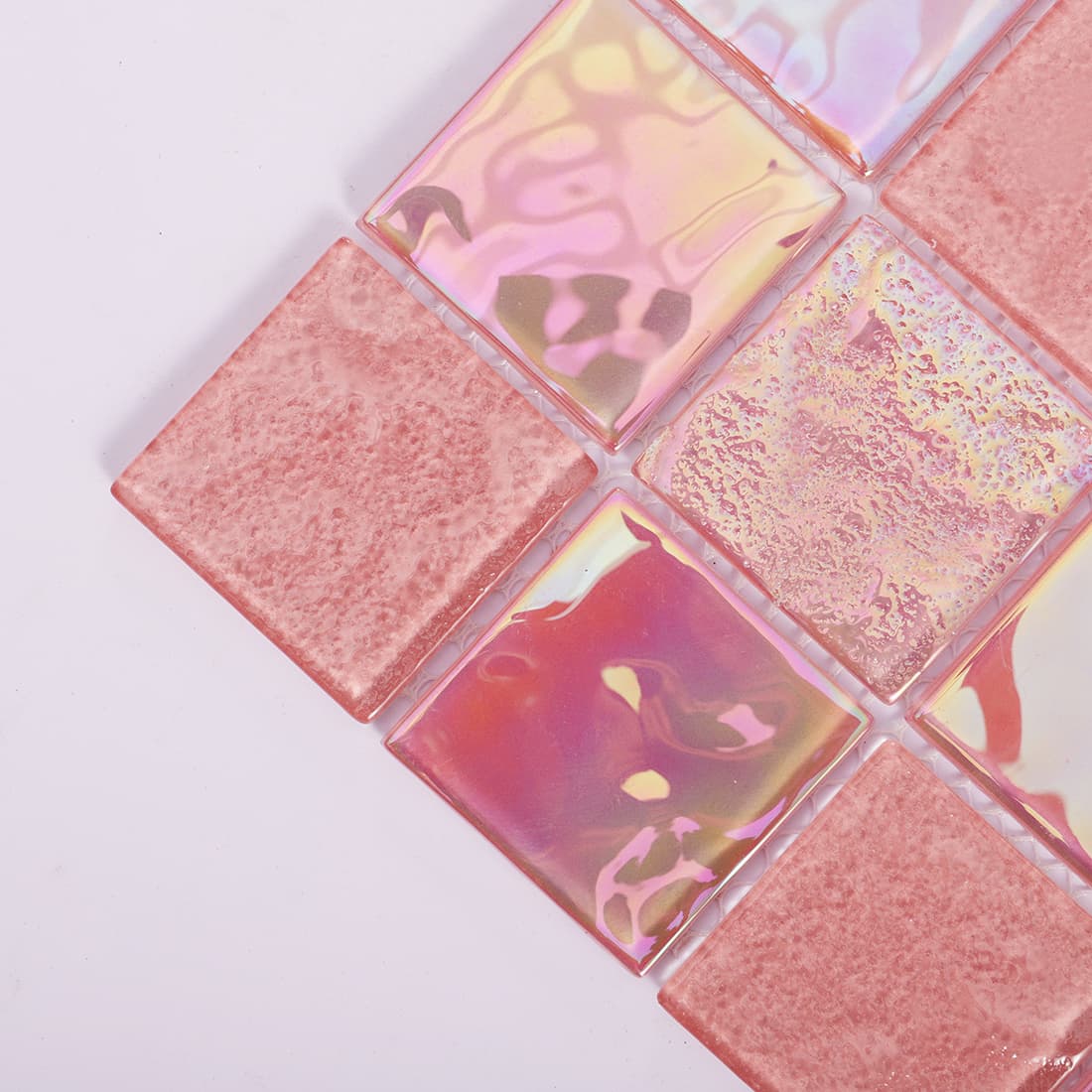 Corner close-up of pink square glass mosaic tile with glossy iridescent finish