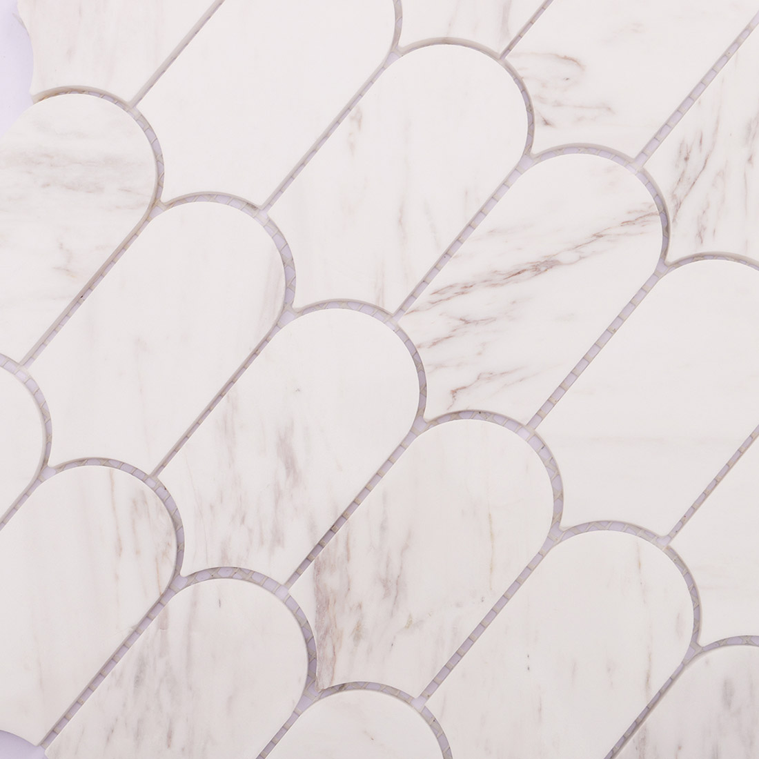 Polished surface detail of white marble fish scale mosaic tiles
