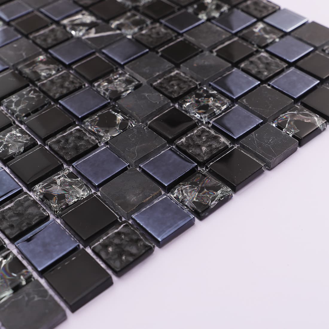 Profile view showing the thickness of glossy black glass and stone tiles.