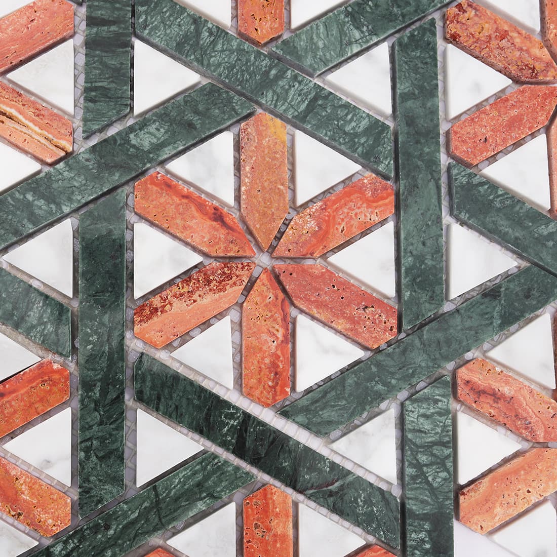 Close up of red and green marble mosaic with white triangle inserts