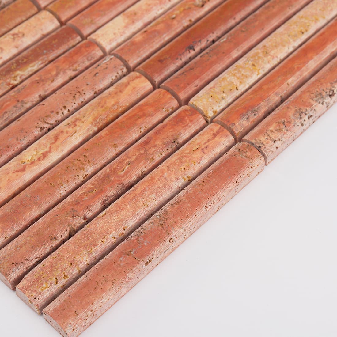 Angled edge view of red travertine finger mosaic tile