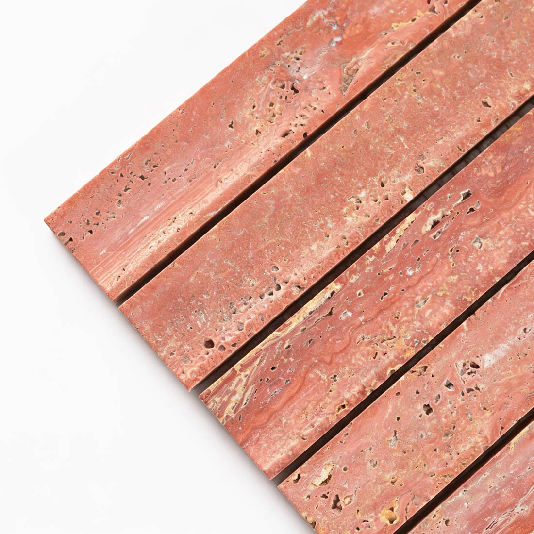 Corner detail of curved red travertine fluted tile.