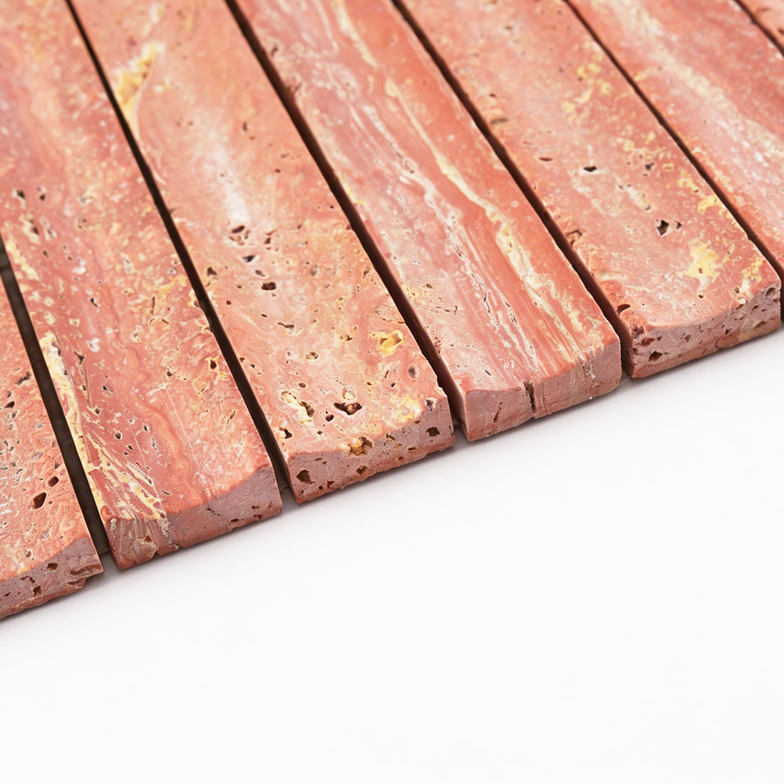 Edge profile of fluted red travertine stacked tile.