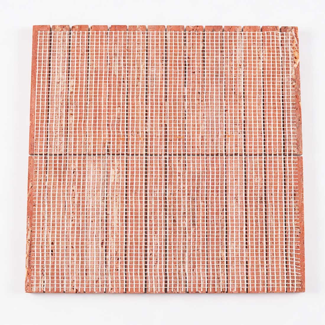 Mesh backing on red travertine linear mosaic.