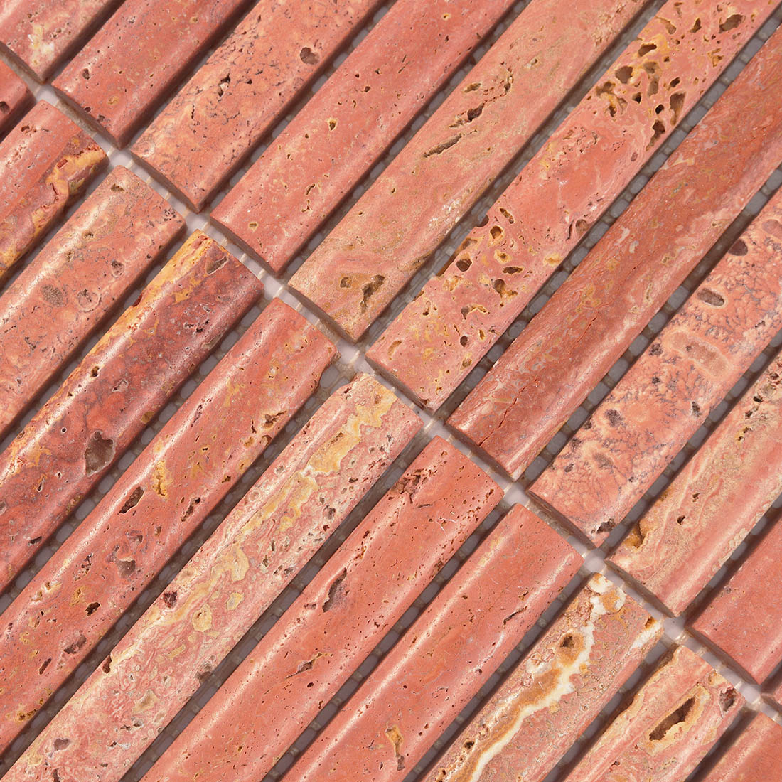 Detailed surface texture showcasing natural pits in red travertine stone.