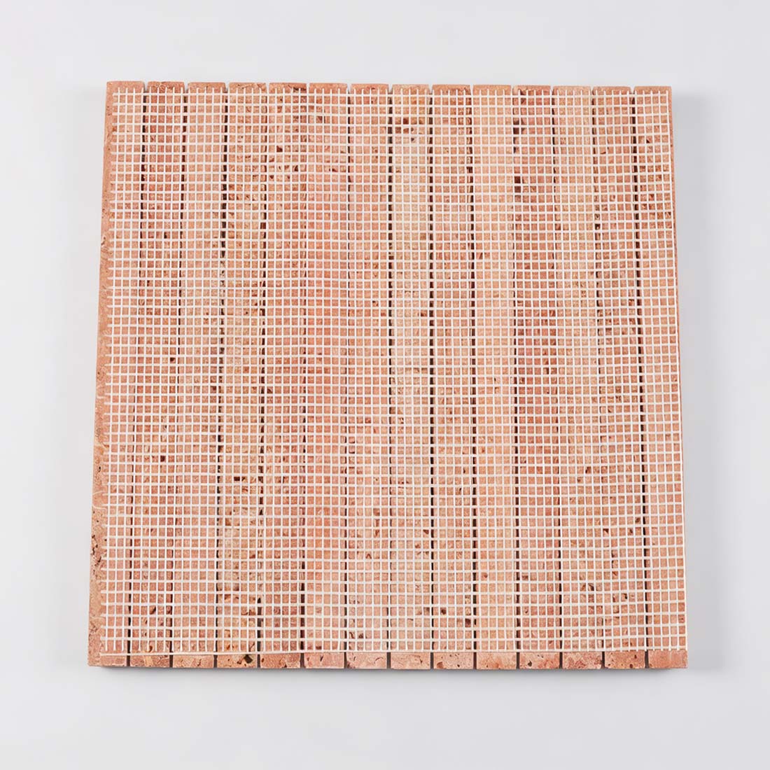 Mesh backing view of red travertine pencil liner tile sheet