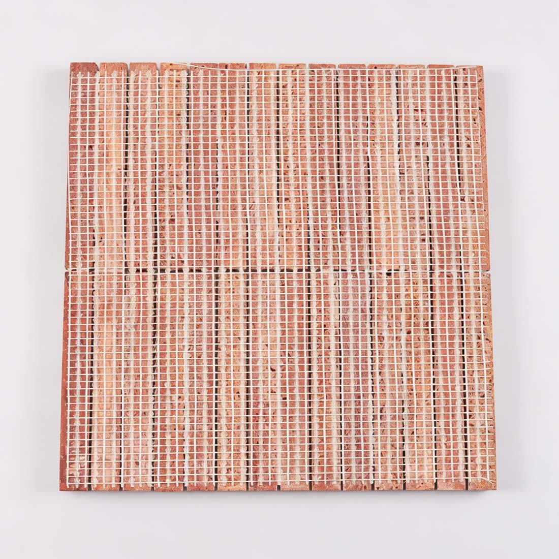 Professional mesh-mounted backing of red travertine rod mosaic tile.