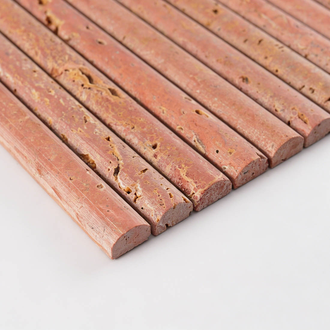 Edge profile of red travertine rounded bar tile showing curved face