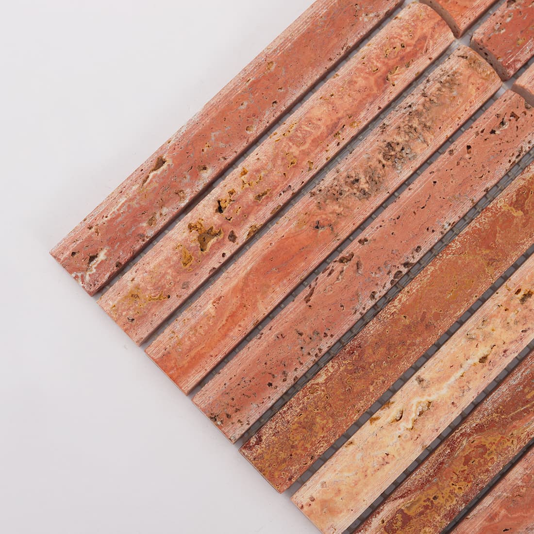 Corner detail of red travertine rounded finger mosaic tile