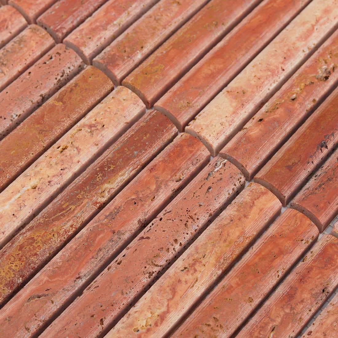 Close-up of red travertine rounded top strip mosaic texture