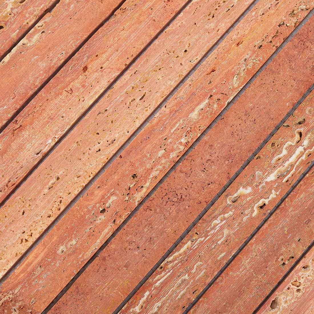 Close-up of red travertine stacked strip mosaic tile surface
