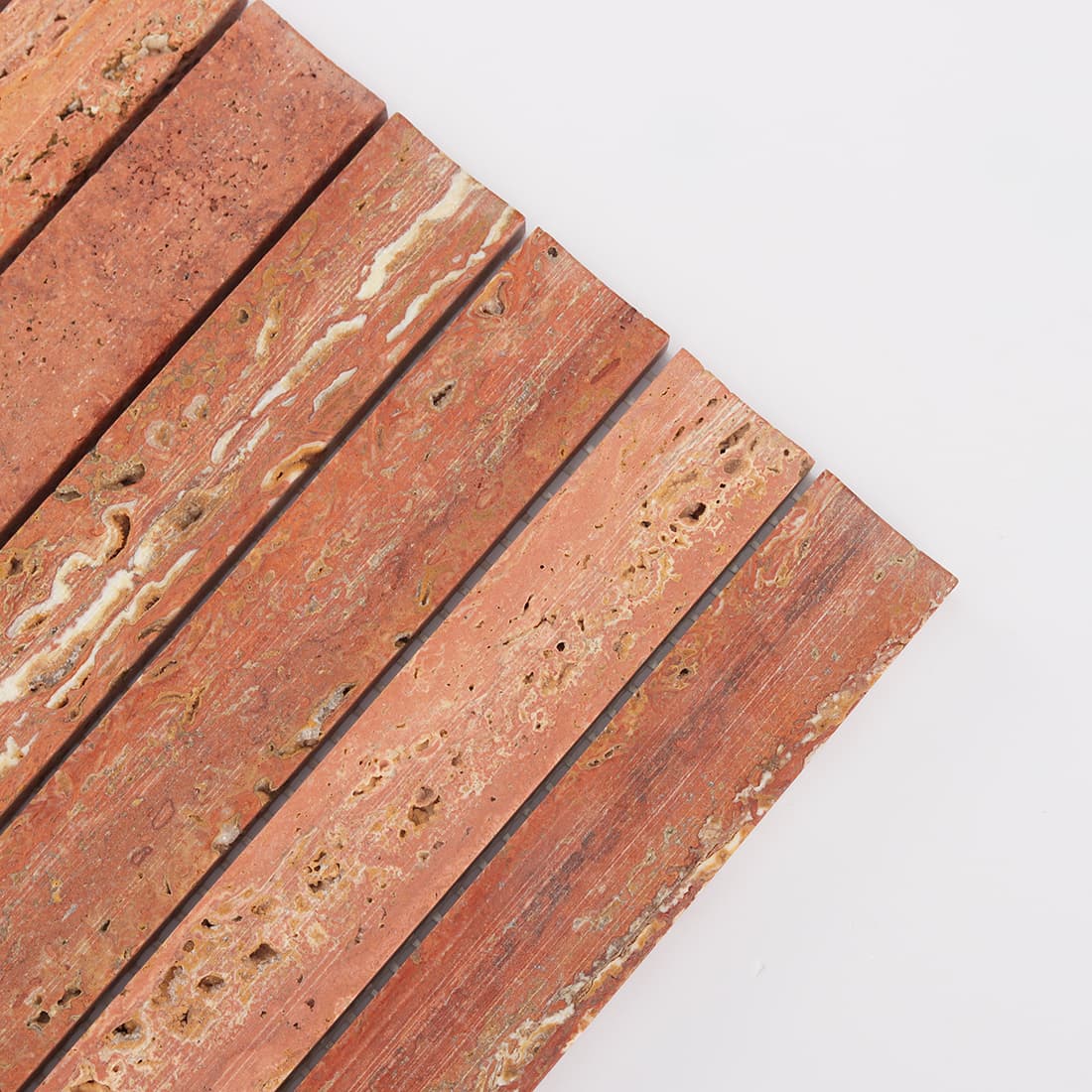 Corner detail of red travertine stacked strip mosaic tile