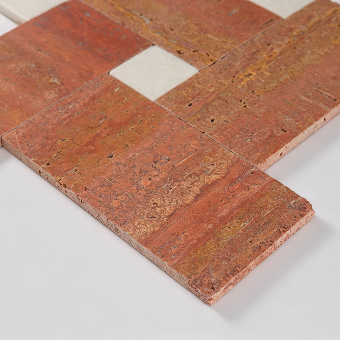 Macro view of red travertine strip tile edge and porous surface