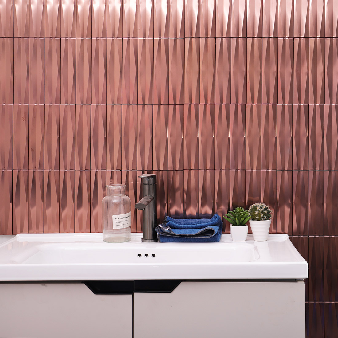 Rose gold 3D linear stainless steel mosaic tile on a modern bathroom wall
