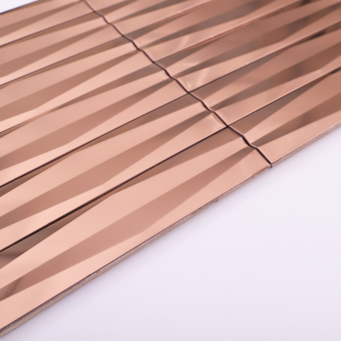 Edge detail of rose gold 3D linear stainless steel mosaic tile sheet