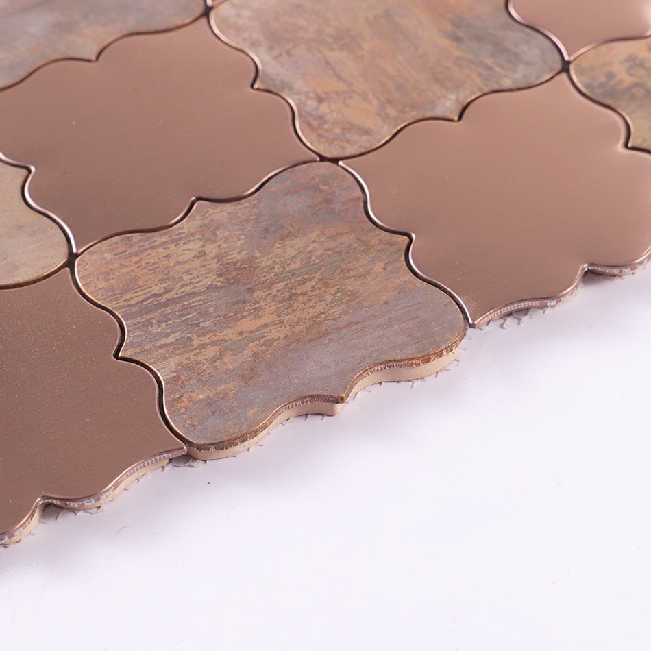 Edge detail of rose gold and antique copper arabesque mosaic tile