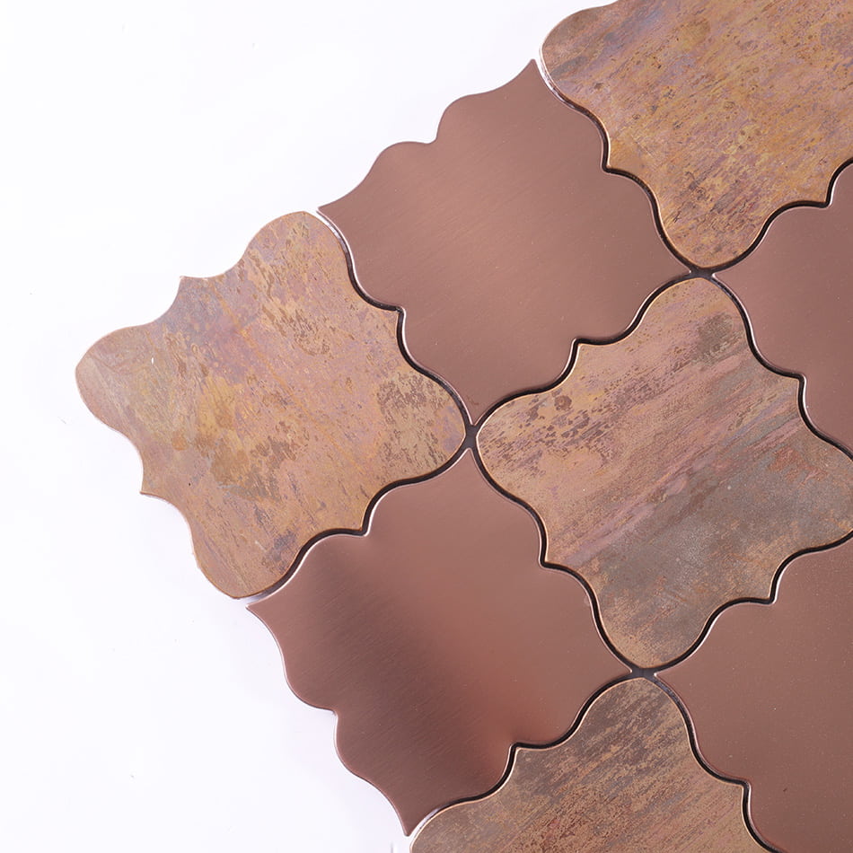 Corner detail of rose gold and antique copper arabesque mosaic tile