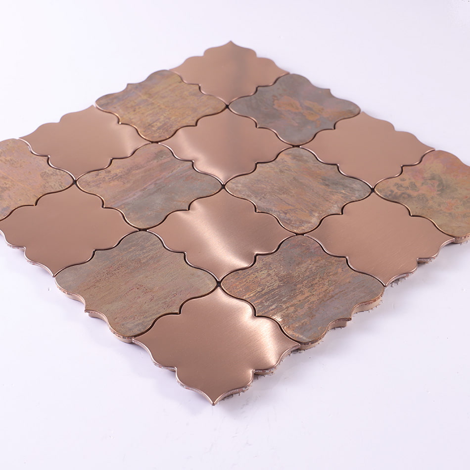 Angled view of rose gold and antique copper arabesque mosaic tile