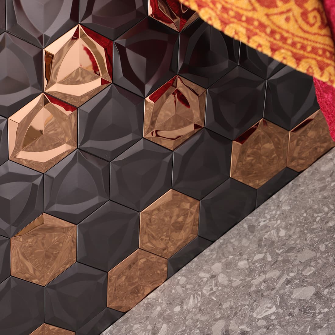 Interior wall installed with rose gold and black 3D hexagon metallic tiles.