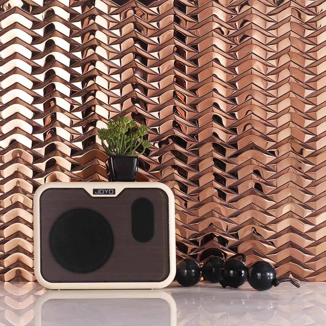 Rose gold chevron metal mosaic tile wall with speaker decor scene