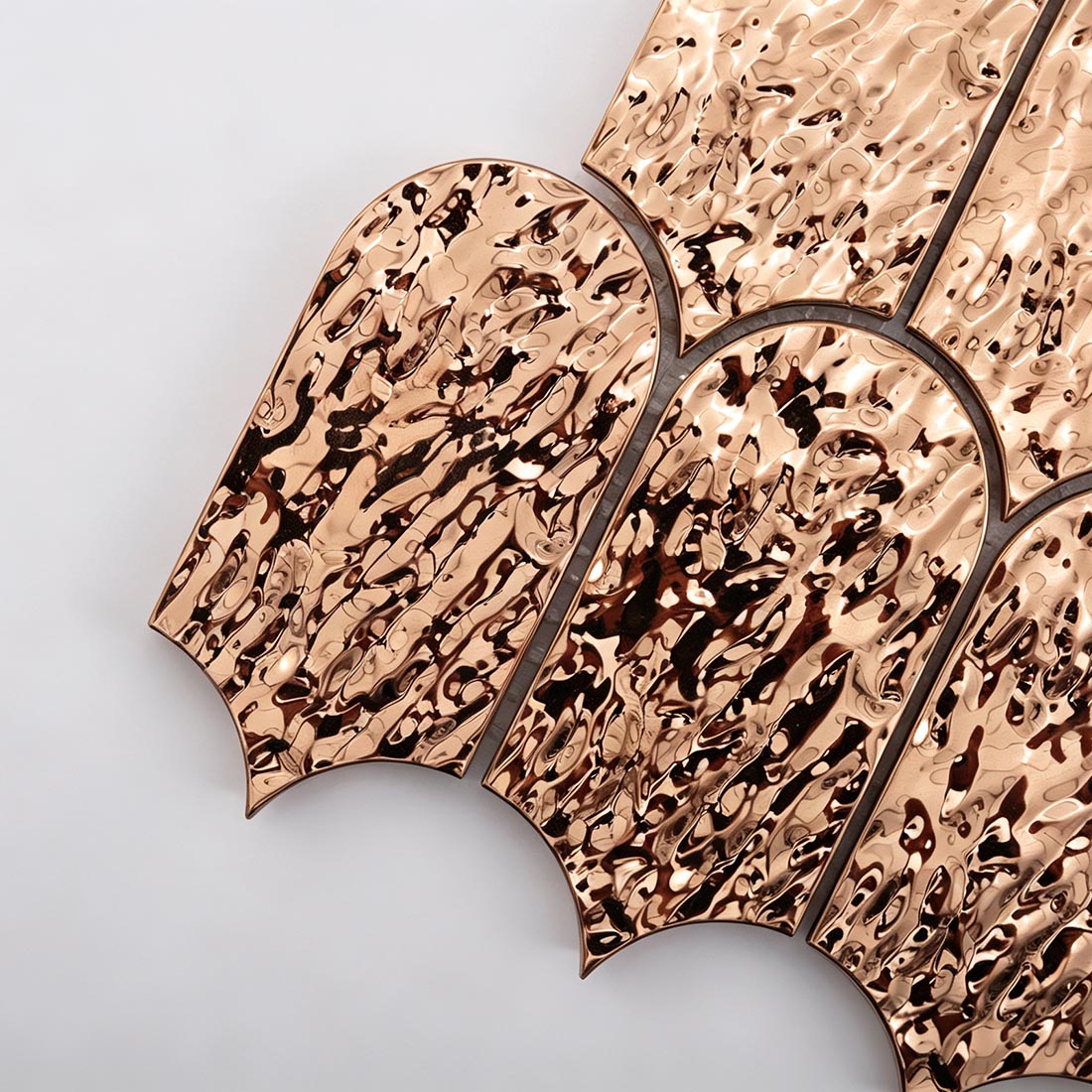 Close up of rose gold fan metal mosaic tile water ripple textured chips