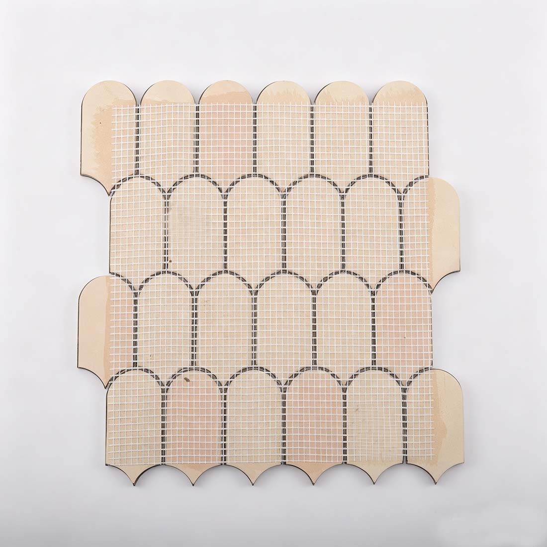 Fiberglass mesh backing on reverse side of rose gold fan metal mosaic tile
