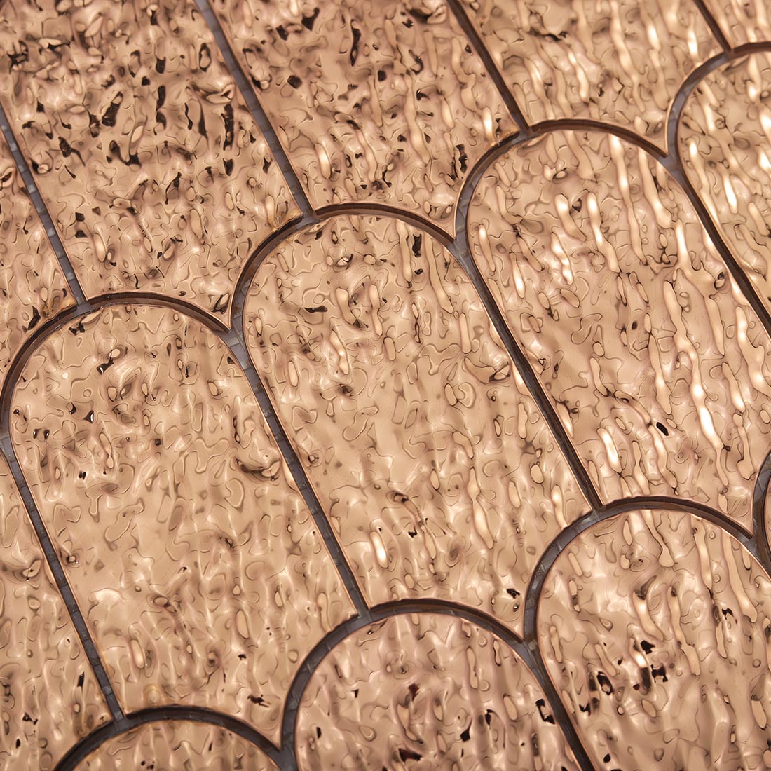Top view showing detailed water ripple texture on rose gold fan stainless tile